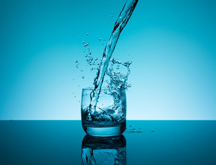 Creative splashing water in the glass