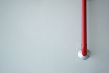 The red pipe on cement wall