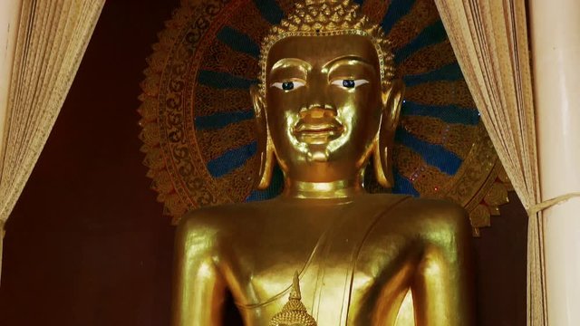 Statue of Golden Buddha in ancient Buddhist temple of the 7th century Wat Phra That Doi Kham in Chiang Mai, Thailand.