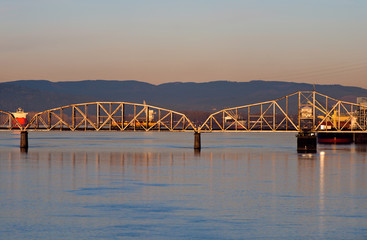 Railway swing bridge over Columbia River at sunrise