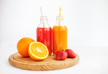 Fruit juice from oranges and strawberries. The concept of beverages, health food and vegetarian.