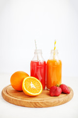  Fruit juice from oranges and strawberries. White background. The concept of beverages, health food and vegetarian.