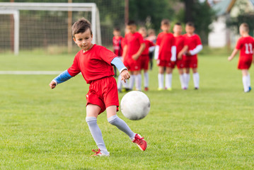 Kids soccer football - children players match on soccer field