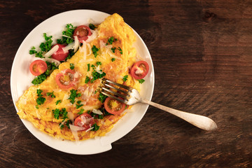 Omelette with parsley, cherry tomatoes, and copyspace