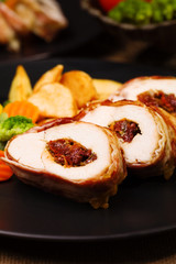 Fototapeta na wymiar Delicious chicken rolls with dried tomatoes and mozzarella.