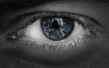 Macro shot of male human eye in black and white toned.