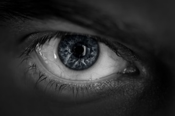 Macro shot of male human eye in black and white toned.