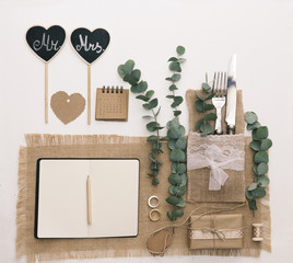 Wedding planner flat lay composition. Notebook with accessories and wedding decorations. Workspace, top view.