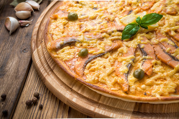 delicious italia pizza in a restaurant, on the wooden desk