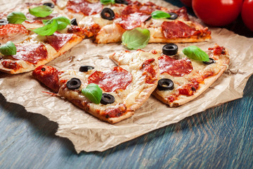 Slices of pizza pepperoni with olives