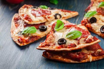 Slices of pizza pepperoni with olives