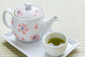 Tea pot with tea cup of matcha green tea.