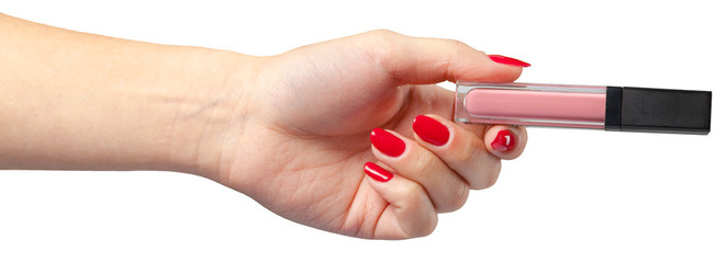 lipstick in hand isolated on white .