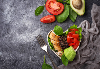 Salad with chicken, black quinoa, tomatoes and avocado