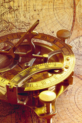 Old compass over ancient map