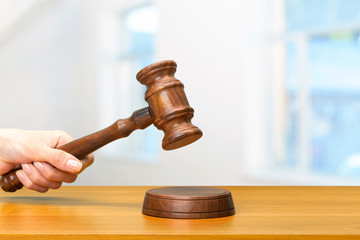 someones hand holding Wooden Law Gavel