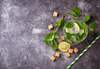 Obraz na płótnie Canvas Summer drink mojito with rum, mint, ice and lime