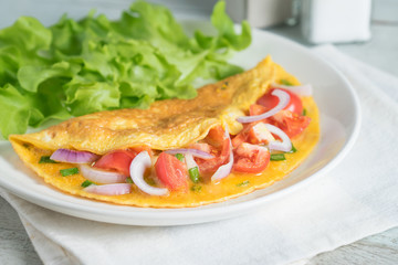 Omelet with shallot and cherry tomato.
