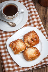 Buns with berries on a wooden table.