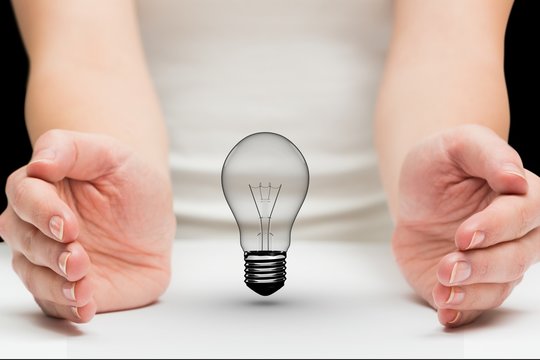 Light bulb between two hands