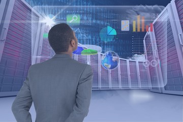 Businessman watching digital screen with graphics