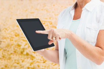 Woman showing her tablet in a field