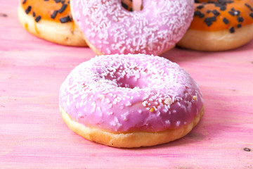 donuts on pink wooden background