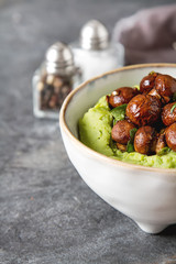 Homemade food. Fried mushrooms cooked with Italian herbs and puree of green peas in a ceramic bowl. Net food, weight loss, the concept of vegetarian food. Copy space.