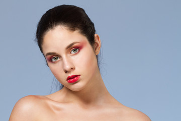 Fashion portrait of girl with bright make up looking at camera.