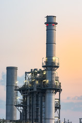 Oil refinery towers and steel pipes at dusk. Maasvlakte, Europoort, The Netherlands