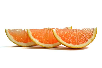 Closeup of grapefruit wedges on a white background