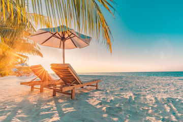 Amazing sunset beach. Romantic couple chairs umbrella sun rays. Tranquil togetherness love wellbeing, relax beautiful landscape. Getaway tropical island coast palm leaves idyllic sea. Dream travel - Powered by Adobe