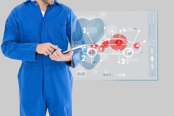 Mechanic using a tablet close to an interface