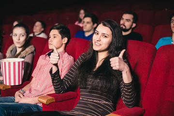 Girl in a movie showing a thumbs up © artem_goncharov