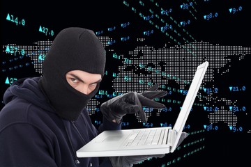 hacker using his laptop against worlds map