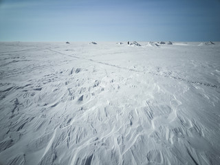Sea in winter in Siberia. Snow and ice on the sea to the shore in the distance with skier