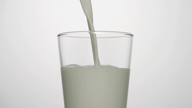 Close-up shot of milk pouring into empty glass