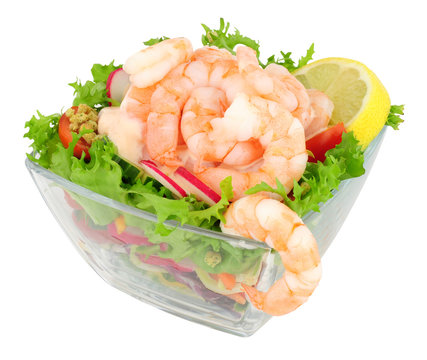 Simple fresh prawn salad in a glass dish isolated on a white background