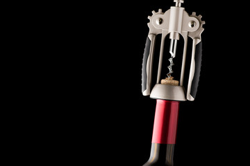 Red wine bottle open with corkscrew