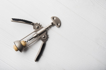 wine corkscrew on white wooden table