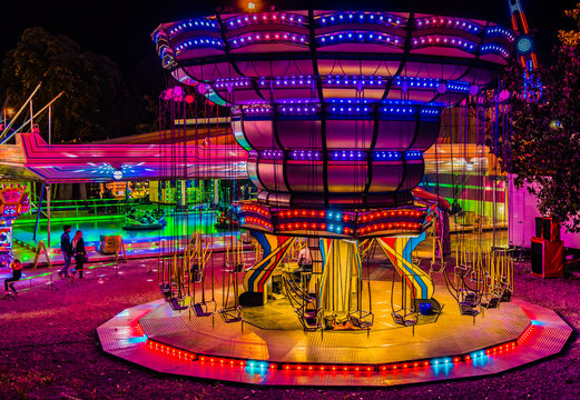 Illuminated colorful night moon with light rides and signs