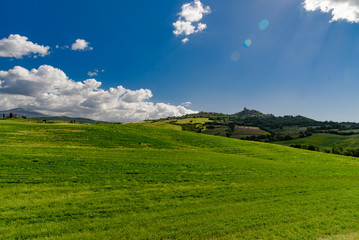 Perfect panorama of green hills with blue sky and fluffy clouds