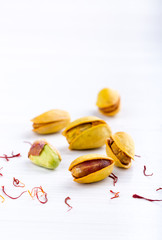 Pistachios in yellow shells roasted with saffron and dried saffron spices