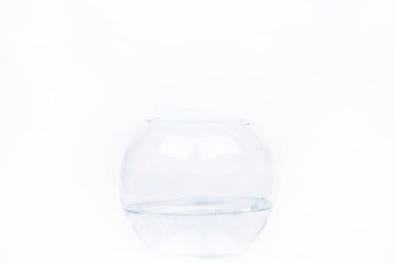 Glass bowl with water stands on white background