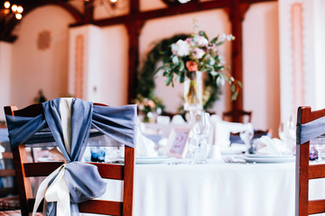 Wooden chair decorated with blue and white ribbons