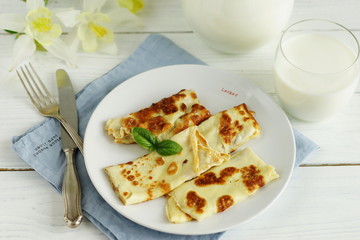 Tasty and healthy breakfast omelette from eggs and fresh milk on a white wooden background.top view
