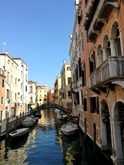 Obraz na płótnie Canvas VENICE, ITALY - MAY 18, 2017 : little canal of Venice with boats and bridge.
