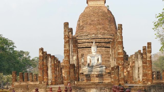 Ancient Buddha statue at sunrise in Sukhotai, Thailand.