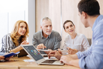 Obraz premium Joyful senior man presenting his report