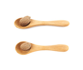 Wooden spoon and pecan nut composition